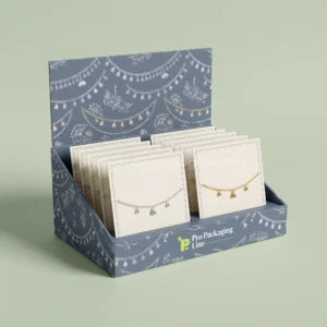 Custom anklet boxes - slate blue counter display box holding anklet cards with silver chain and bell print by Pro Packaging Line