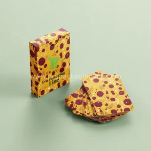 Mustard and burgundy card game tuck box with cards