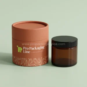 Custom terracotta cylinder paper tube cream box with leaf line pattern beside an amber glass cream jar