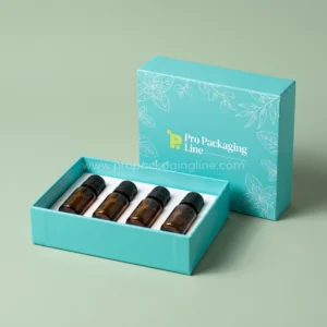 Custom turquoise lid and base essential oil box with mint leaf art holding four amber oil bottles