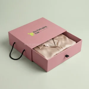 Dusty rose drawer garment box with rope handles and silk blouse, Pro Packaging Line logo