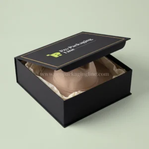 Luxury black rigid magnetic hat box with gold border and beige fedora, Pro Packaging Line logo on the lid
