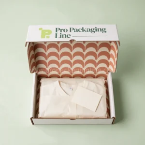 Overhead view of a custom white mailer box with terracotta arch-print interior, tissue-wrapped garment and thank-you card by Pro Packaging Line