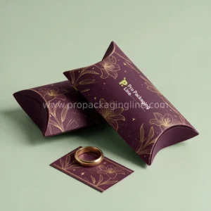 Custom ring boxes - plum cardstock pillow boxes with gold lily artwork and matching ring card by Pro Packaging Line