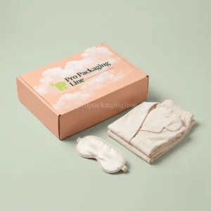 Peach cloud-print sleepwear mailer box with cream pajamas and sleep mask, Pro Packaging Line logo