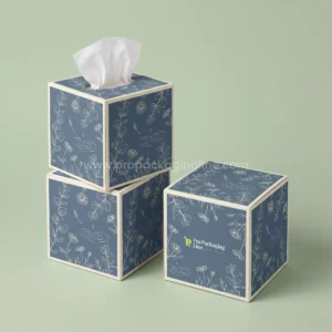 Custom tissue boxes: slate blue cube tissue boxes with eucalyptus and chamomile line art, Pro Packaging Line logo
