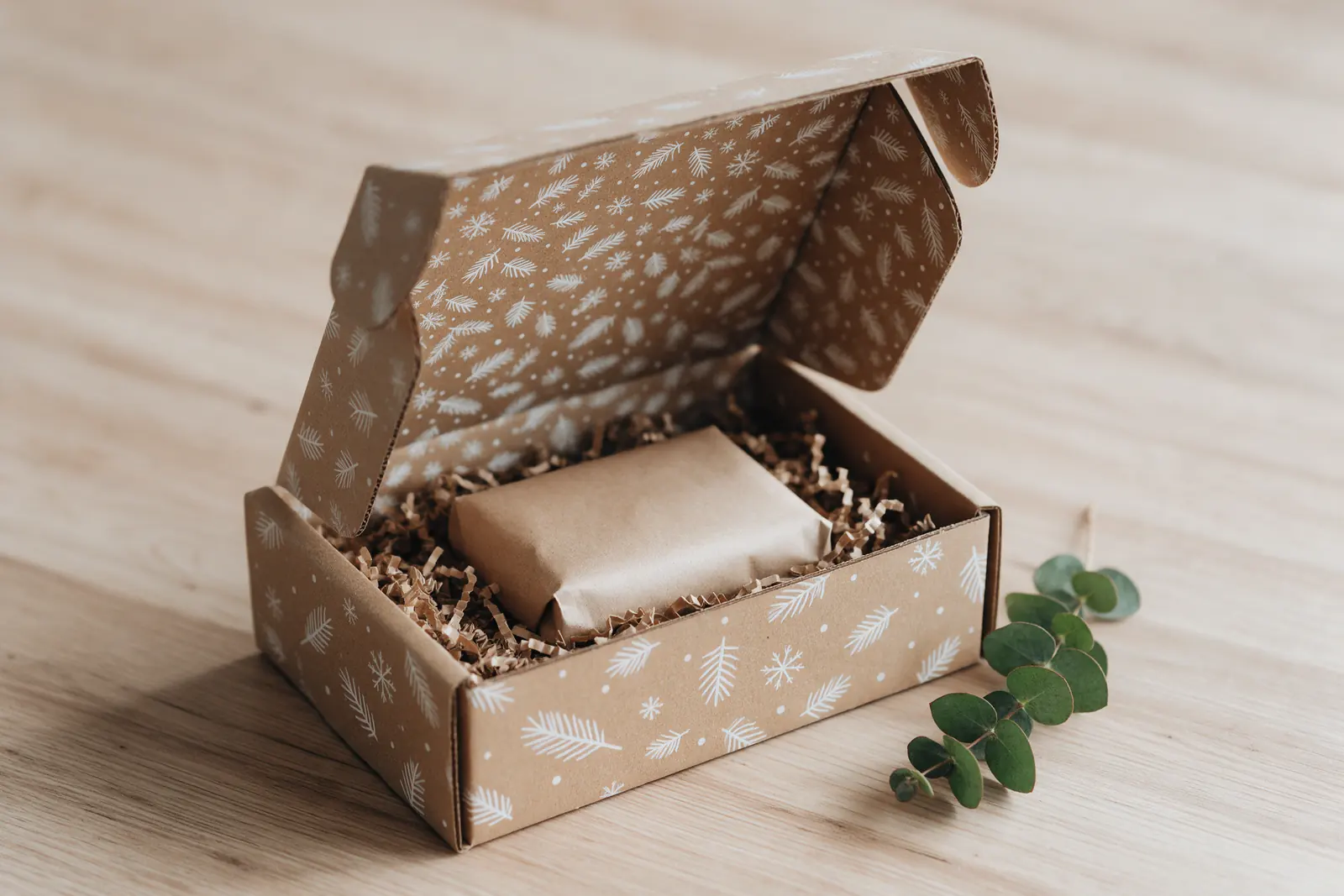 Kraft mailer box with white winter print inside and out, lid open