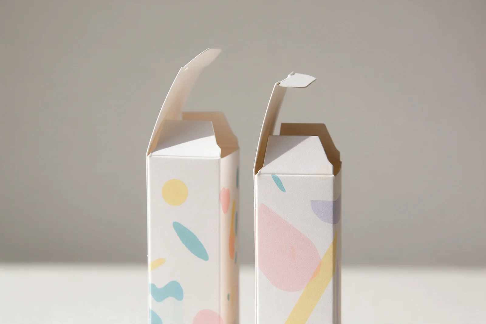 Printed paperboard tuck-end cartons with top tuck flaps open